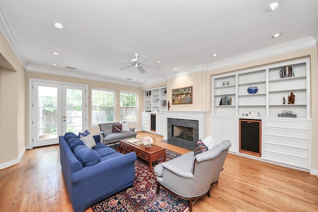 3820 Purdue St, Houston, TX 77005 - living room featuring a high end fireplace, light wood finished floors, crown molding, a ceiling fan, and recessed lighting