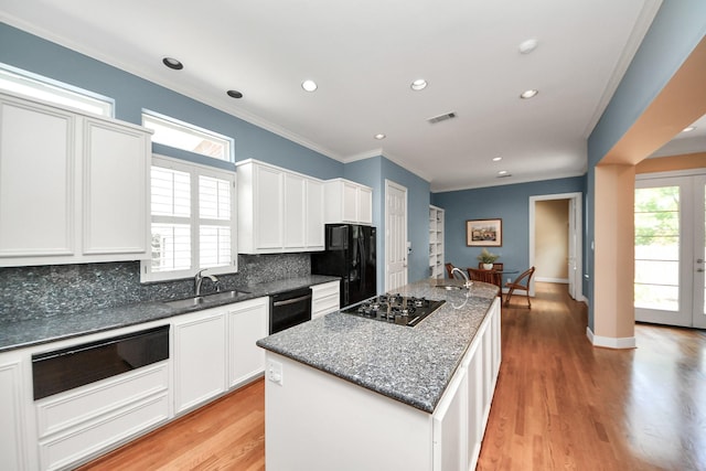 3820 Purdue St, Houston, TX 77005 - kitchen with black appliances, a sink, a warming drawer, decorative backsplash, and crown molding