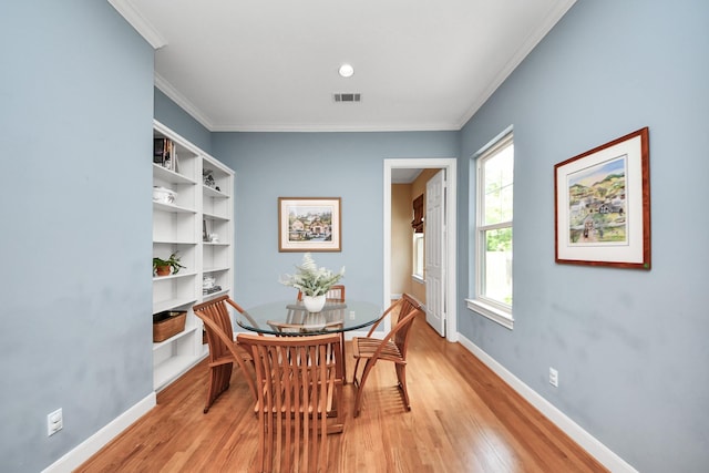 3820 Purdue St, Houston, TX 77005 - dining room with light wood finished floors, crown molding, and baseboards