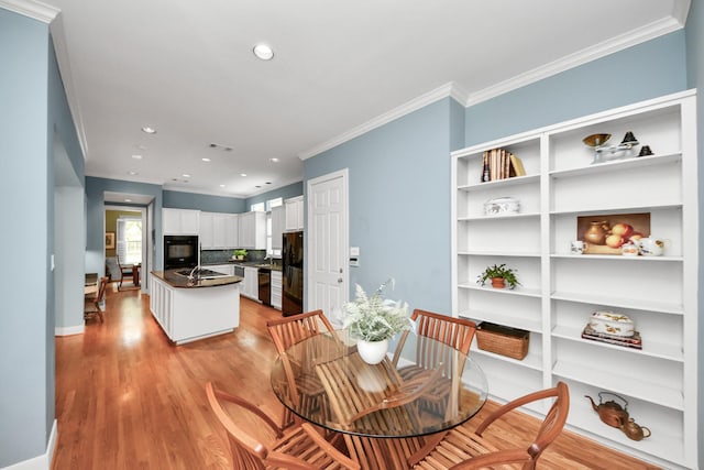 3820 Purdue St, Houston, TX 77005 - dining area with crown molding, light wood-style floors, recessed lighting, and baseboards