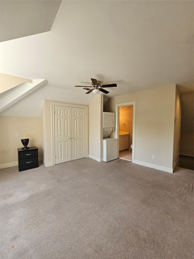 3820 Purdue St, Houston, TX 77005 - unfurnished bedroom with stacked washing machine and dryer, vaulted ceiling, carpet floors, baseboards, and a closet