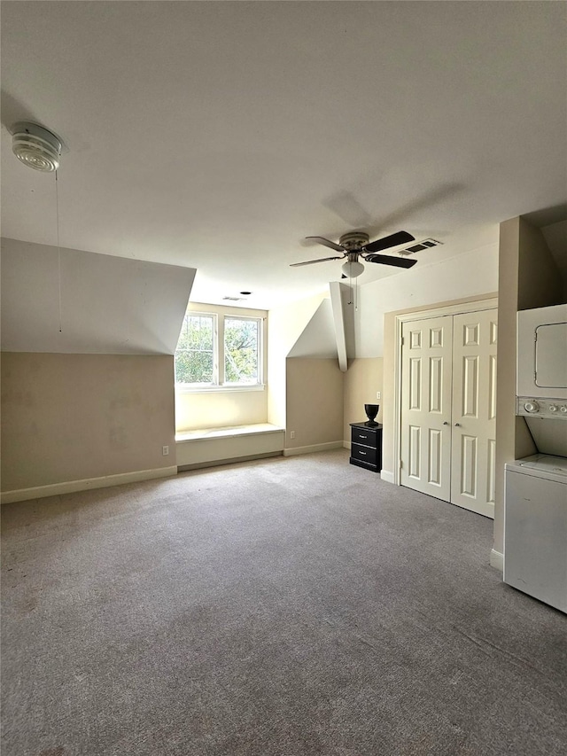 3820 Purdue St, Houston, TX 77005 - additional living space with stacked washing machine and dryer, carpet flooring, ceiling fan, baseboards, and vaulted ceiling