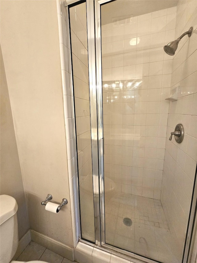 3820 Purdue St, Houston, TX 77005 - bathroom featuring a stall shower, toilet, baseboards, and tile patterned flooring