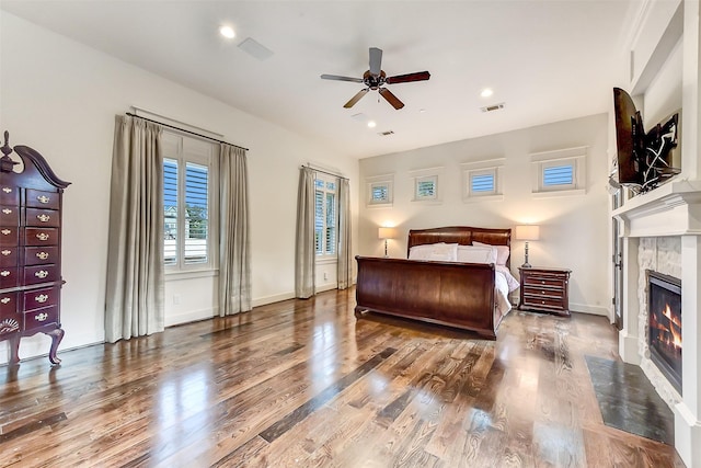 8305 Will Jordan Pkwy, Bellaire, TX 77401 - bedroom featuring a fireplace, wood finished floors, baseboards, and recessed lighting