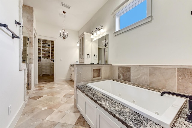 8305 Will Jordan Pkwy, Bellaire, TX 77401 - full bath with a chandelier, vanity, a whirlpool tub, a shower stall, and a walk in closet