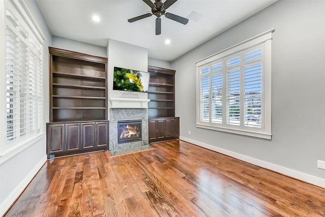 8305 Will Jordan Pkwy, Bellaire, TX 77401 - unfurnished living room with baseboards, a premium fireplace, wood finished floors, a ceiling fan, and recessed lighting