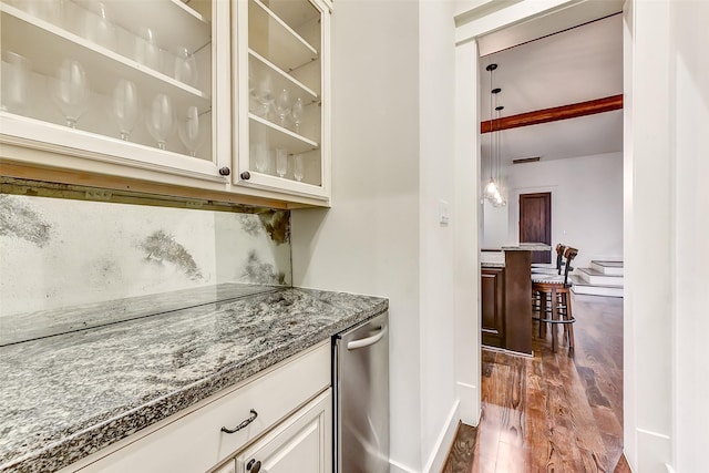 8305 Will Jordan Pkwy, Bellaire, TX 77401 - bar area featuring dark wood-style floors, baseboards, and dishwasher