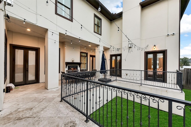 8305 Will Jordan Pkwy, Bellaire, TX 77401 - view of patio featuring french doors and a lit fireplace