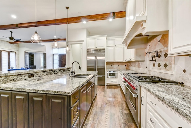 8305 Will Jordan Pkwy, Bellaire, TX 77401 - kitchen with a sink, high end appliances, beam ceiling, dark brown cabinets, and ceiling fan