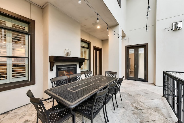 8305 Will Jordan Pkwy, Bellaire, TX 77401 - view of patio with french doors, a glass covered fireplace, and outdoor dining area