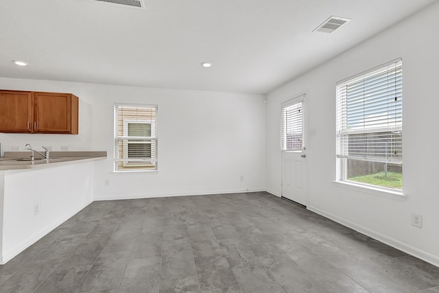 19311 Old Finch Ct, Houston, TX 77073 - kitchen featuring plenty of natural light, brown cabinetry, and recessed lighting