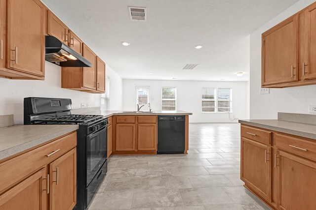 19311 Old Finch Ct, Houston, TX 77073 - kitchen featuring black appliances, under cabinet range hood, a sink, a peninsula, and light countertops
