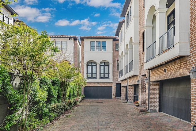 3917 Gramercy St, Houston, TX 77025 - view of front facade featuring an attached garage, driveway, and stucco siding