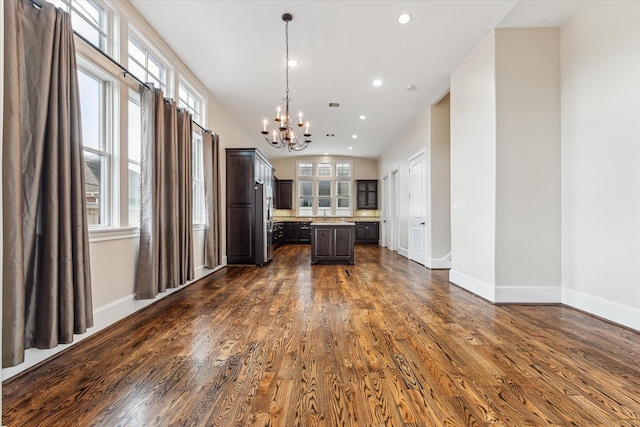 3917 Gramercy St, Houston, TX 77025 - kitchen featuring a chandelier, a center island, light countertops, dark brown cabinetry, and dark wood-style flooring