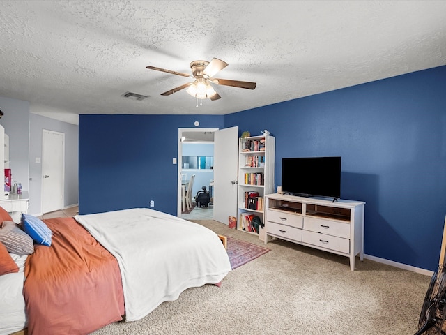 9731 Rocky Hollow Rd, La Porte, TX 77571 - carpeted bedroom featuring a textured ceiling, ceiling fan, and baseboards