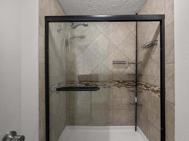 9731 Rocky Hollow Rd, La Porte, TX 77571 - full bathroom featuring a stall shower, a textured ceiling, and a textured wall