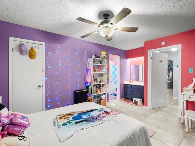 9731 Rocky Hollow Rd, La Porte, TX 77571 - bedroom featuring a textured ceiling, light tile patterned floors, ensuite bathroom, and ceiling fan