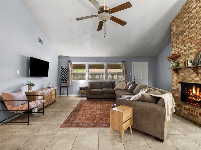 9731 Rocky Hollow Rd, La Porte, TX 77571 - living room with a textured ceiling, ceiling fan, light tile patterned floors, a fireplace, and high vaulted ceiling