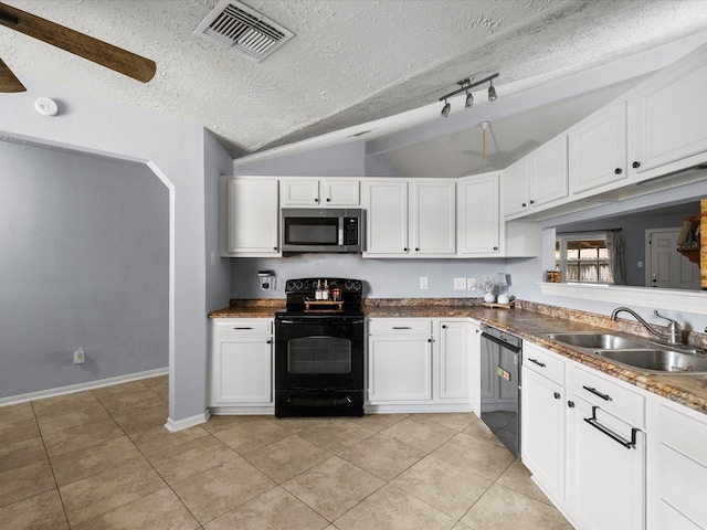 9731 Rocky Hollow Rd, La Porte, TX 77571 - kitchen with appliances with stainless steel finishes, a sink, lofted ceiling, white cabinets, and light tile patterned floors