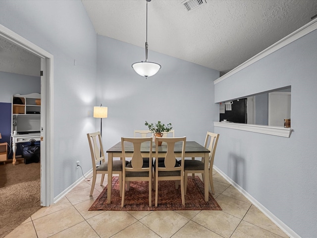 9731 Rocky Hollow Rd, La Porte, TX 77571 - dining space featuring a textured ceiling, light tile patterned floors, baseboards, and vaulted ceiling