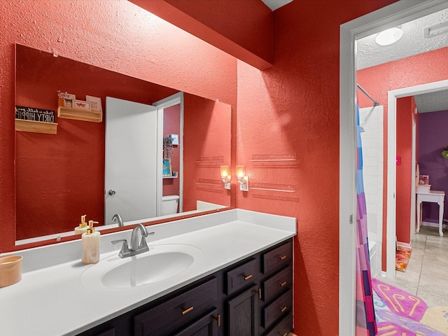9731 Rocky Hollow Rd, La Porte, TX 77571 - bathroom with toilet, vanity, tile patterned flooring, a textured wall, and shower / bath combination with curtain
