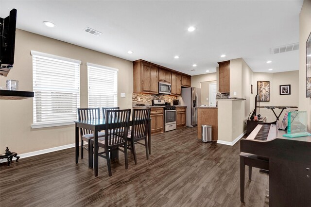 5815 Cebra St, Houston, TX 77091 - dining room with dark wood-style floors, baseboards, and recessed lighting