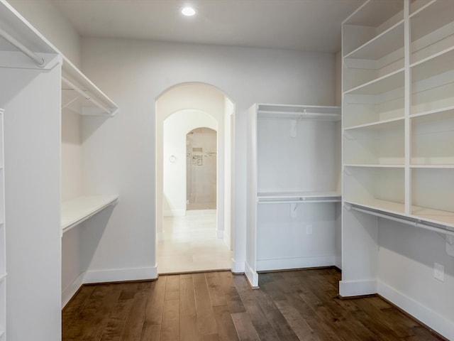 2301 Arabelle St, Houston, TX 77007 - walk in closet featuring arched walkways and dark wood-type flooring