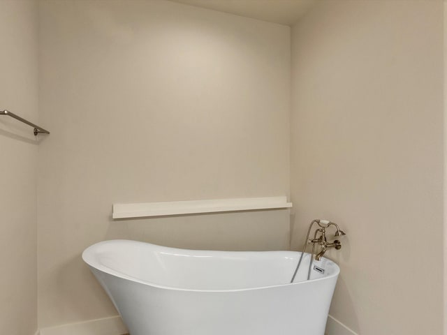 2301 Arabelle St, Houston, TX 77007 - bathroom featuring baseboards and a freestanding bath