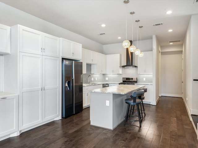 2301 Arabelle St, Houston, TX 77007 - kitchen with appliances with stainless steel finishes, wall chimney range hood, a sink, white cabinets, and backsplash