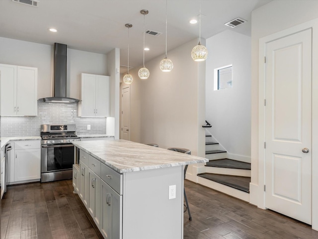 2301 Arabelle St, Houston, TX 77007 - kitchen featuring stainless steel gas range, wall chimney range hood, dark wood-style flooring, a kitchen island, and recessed lighting