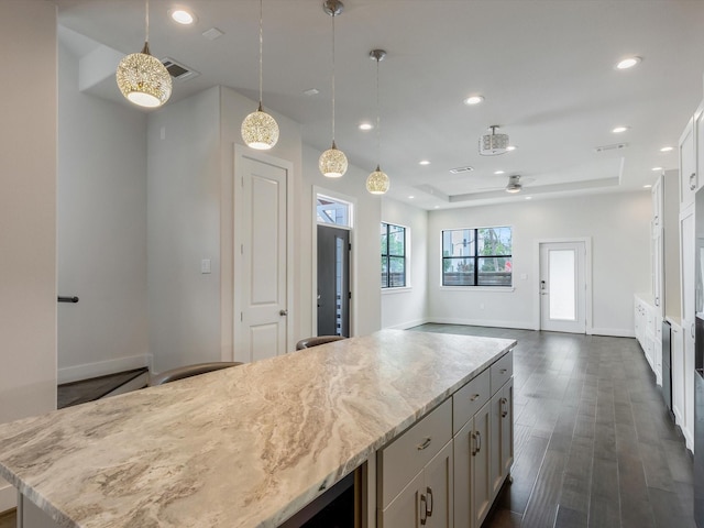 2301 Arabelle St, Houston, TX 77007 - kitchen featuring a kitchen island, light stone counters, dark wood-style flooring, baseboards, and recessed lighting