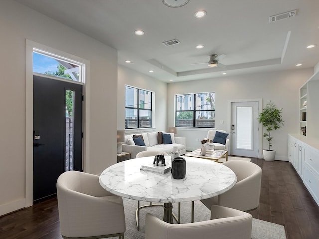 2301 Arabelle St, Houston, TX 77007 - dining room with healthy amount of natural light, dark wood-style flooring, a tray ceiling, a ceiling fan, and recessed lighting