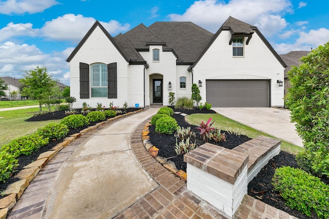 15603 Adobe Brick Ct, Cypress, TX 77433 - french country inspired facade with a garage, a shingled roof, and driveway