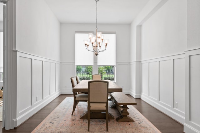 15603 Adobe Brick Ct, Cypress, TX 77433 - dining area with a decorative wall, a chandelier, dark wood-style flooring, and a wainscoted wall