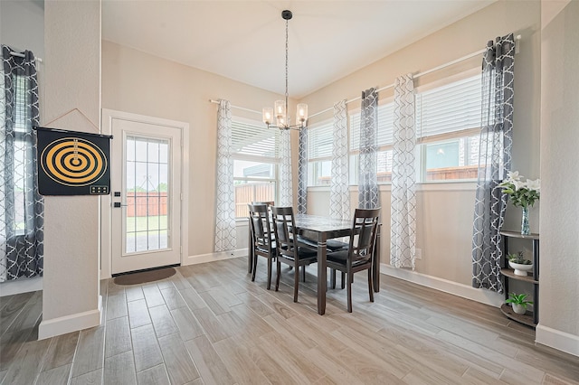 13811 Via Toluca Trl, Cypress, TX 77433 - dining room featuring a chandelier, wood finished floors, baseboards, and plenty of natural light