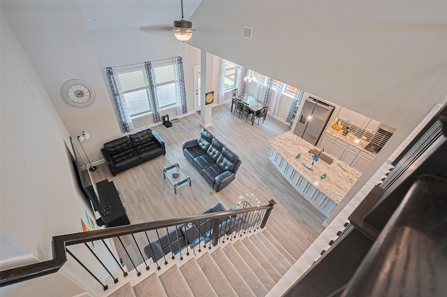 13811 Via Toluca Trl, Cypress, TX 77433 - stairway featuring high vaulted ceiling, baseboards, ceiling fan, and wood finished floors