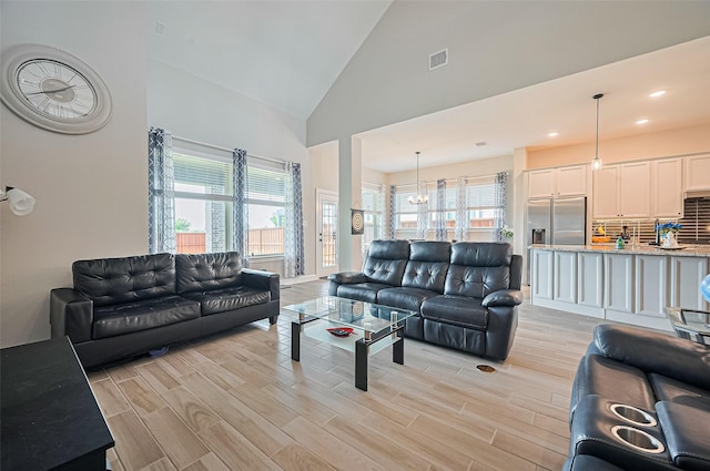 13811 Via Toluca Trl, Cypress, TX 77433 - living area featuring light wood-type flooring, high vaulted ceiling, recessed lighting, and a chandelier