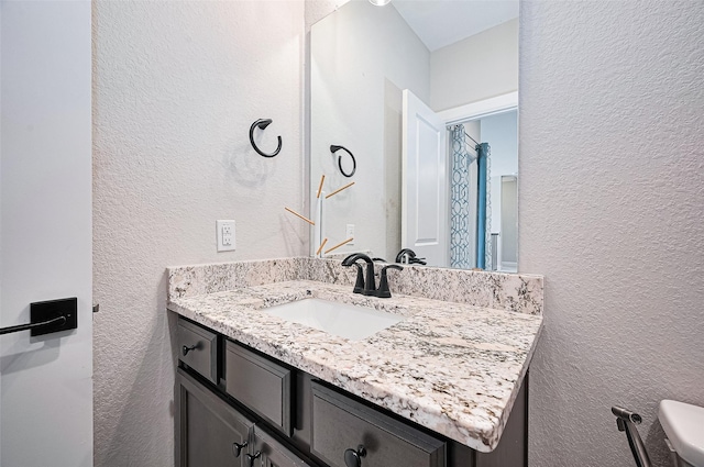 13811 Via Toluca Trl, Cypress, TX 77433 - bathroom with a textured wall, vanity, and toilet