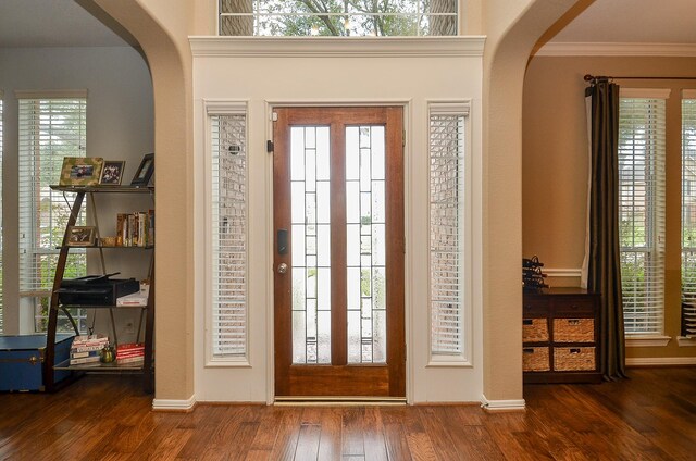 13023 Forester Canyon Ln, Sugar Land, TX 77498 - entryway featuring arched walkways, wood finished floors, ornamental molding, and baseboards