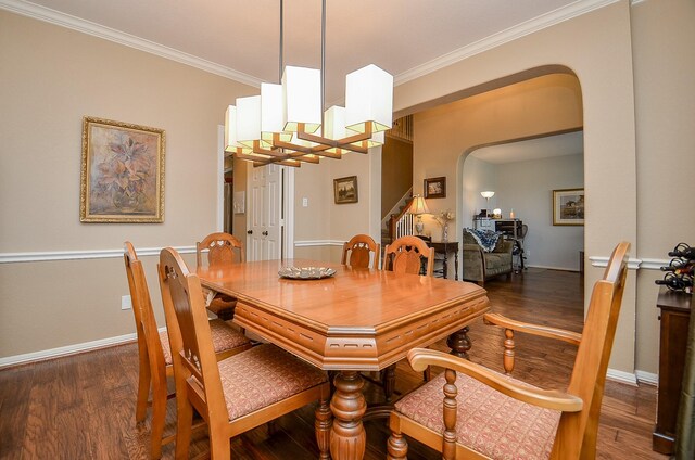 13023 Forester Canyon Ln, Sugar Land, TX 77498 - dining space with arched walkways, crown molding, wood finished floors, baseboards, and stairway