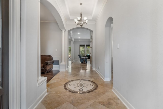 700 Southfield Dr, Friendswood, TX 77546 - entryway featuring arched walkways, inlaid floor details, ornate columns, ornamental molding, and a raised ceiling