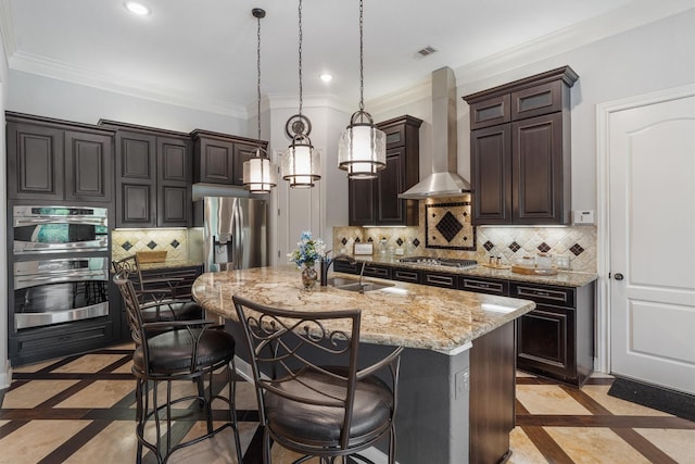 700 Southfield Dr, Friendswood, TX 77546 - kitchen with wall chimney range hood, inlaid floor details, recessed lighting, a kitchen bar, and decorative backsplash