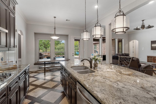 700 Southfield Dr, Friendswood, TX 77546 - kitchen featuring arched walkways, inlaid floor details, light stone countertops, decorative light fixtures, and crown molding
