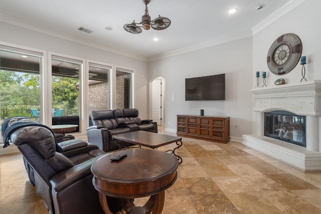 700 Southfield Dr, Friendswood, TX 77546 - living area with arched walkways, ornamental molding, a glass covered fireplace, recessed lighting, and a chandelier