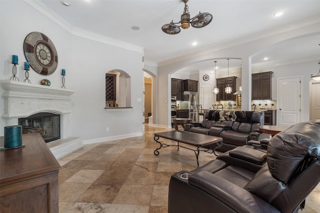 700 Southfield Dr, Friendswood, TX 77546 - living area featuring arched walkways, crown molding, a glass covered fireplace, and recessed lighting