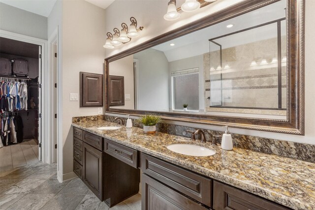 700 Southfield Dr, Friendswood, TX 77546 - bathroom featuring double vanity, a stall shower, a walk in closet, and tile patterned floors