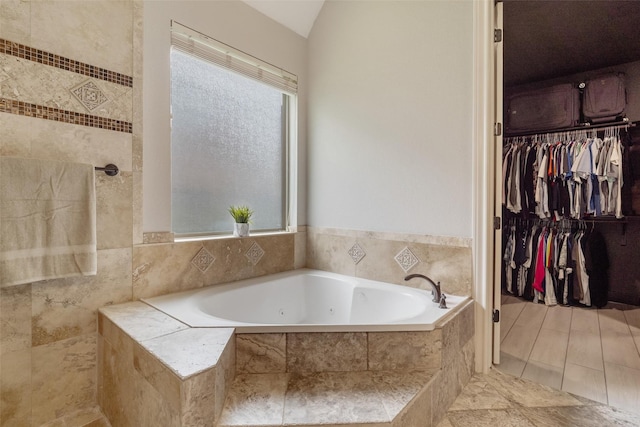 700 Southfield Dr, Friendswood, TX 77546 - bathroom featuring a tub with jets, plenty of natural light, and a walk in closet