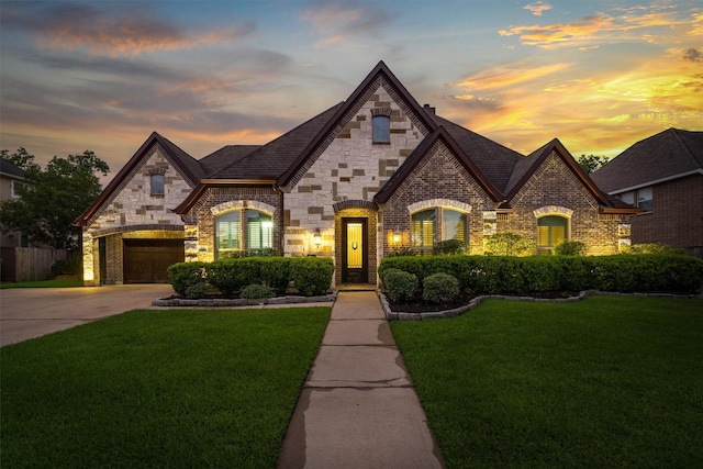 700 Southfield Dr, Friendswood, TX 77546 - french country home with a lawn, driveway, stone siding, and a garage