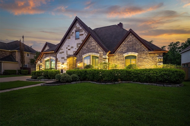 700 Southfield Dr, Friendswood, TX 77546 - view of front of home with stone siding, a yard, a chimney, and brick siding
