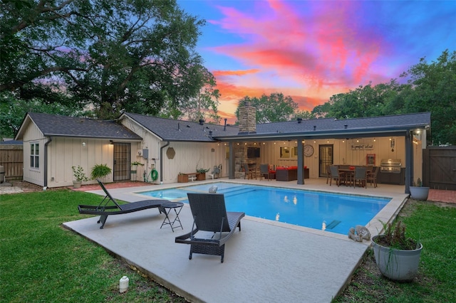 5526 Lincrest Ln, Houston, TX 77056 - back of house at dusk featuring board and batten siding, a patio, a chimney, and an outdoor hangout area